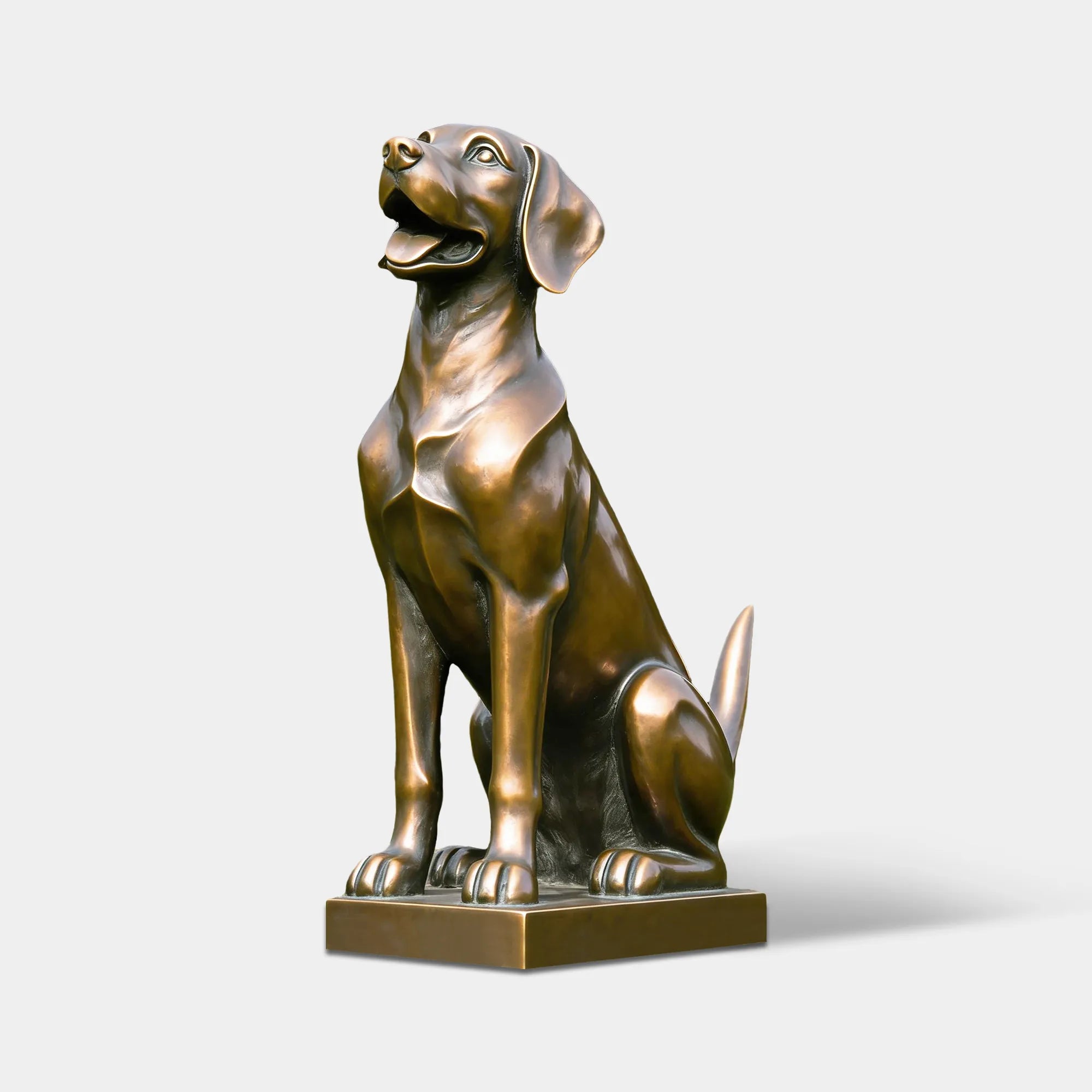 A cute bronze dog sculpture stands on small base amid green lawn and dense leafy shrubbery.