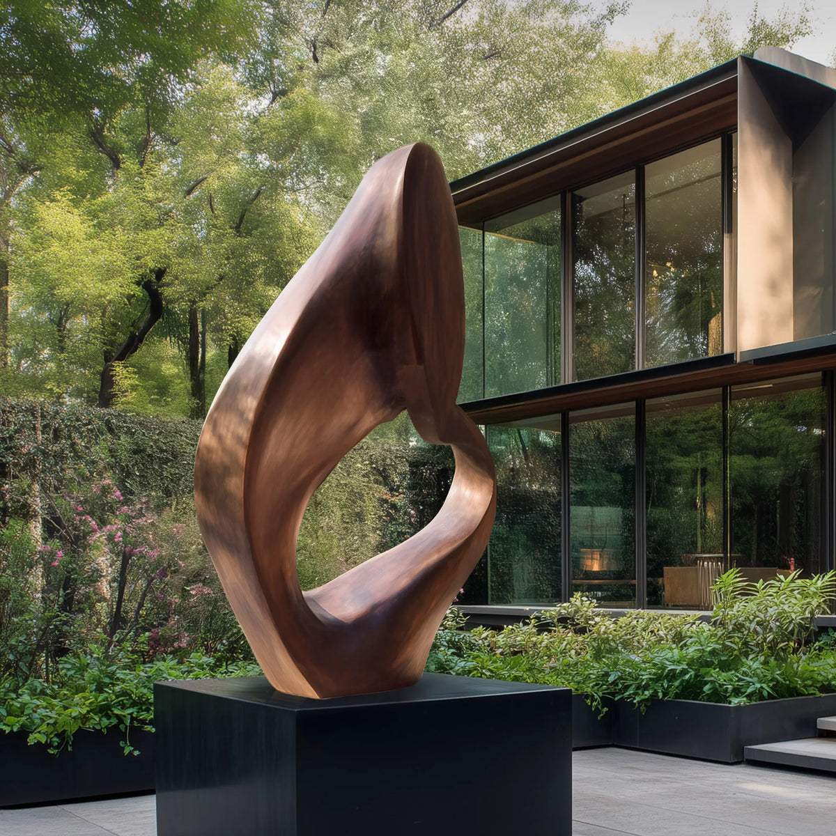 Warm bronze sculpture with a twisted organic silhouette and large open center on a black pedestal in a modern courtyard.