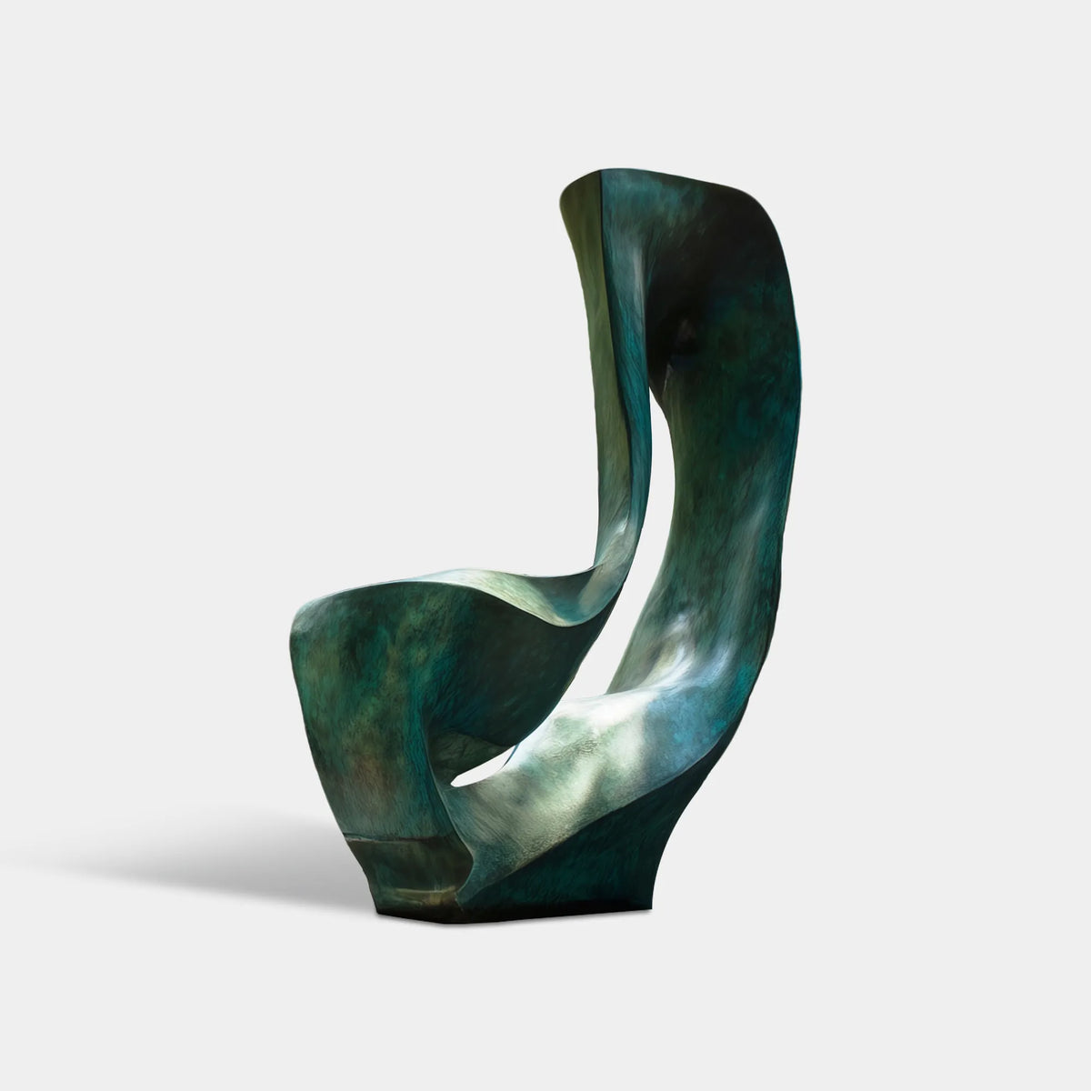 Large bronze abstract sculpture with folded organic forms and a central opening in a modern woodland residence courtyard.