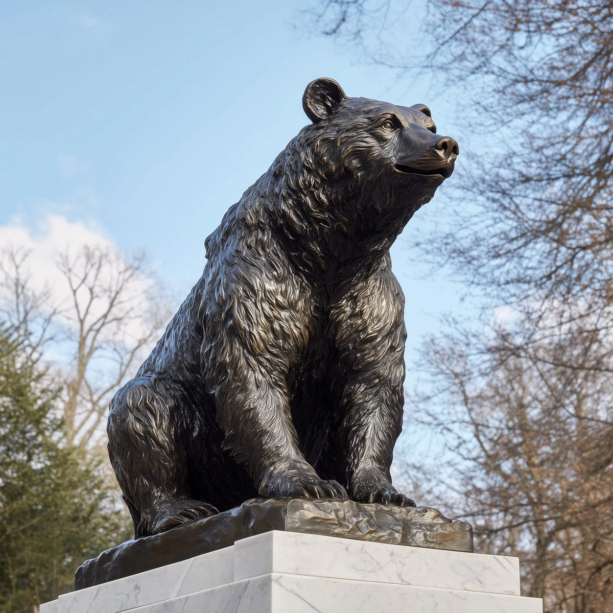 Lifelike seated bear sculpture with detailed fur on a  pedestal in a landscaped park.