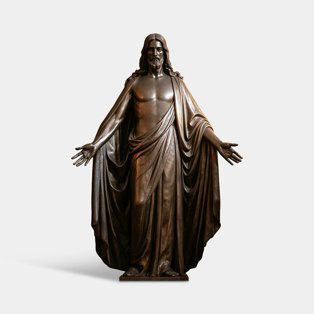 A bronze Jesus statue stands in an arched church alcove behind wooden pews.