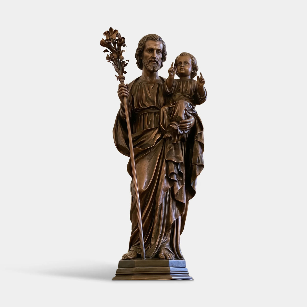 Brown bronze Saint Joseph religious statue holding the Child Jesus with lily staff in a Catholic church sanctuary.