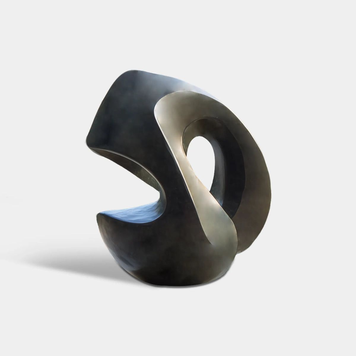 Dark bronze abstract loop sculpture with smooth curved surfaces in a modern villa garden