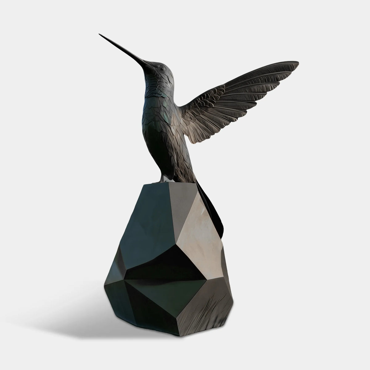 A bronze hummingbird statue with spread wings rests on a geometric base in pond water.
