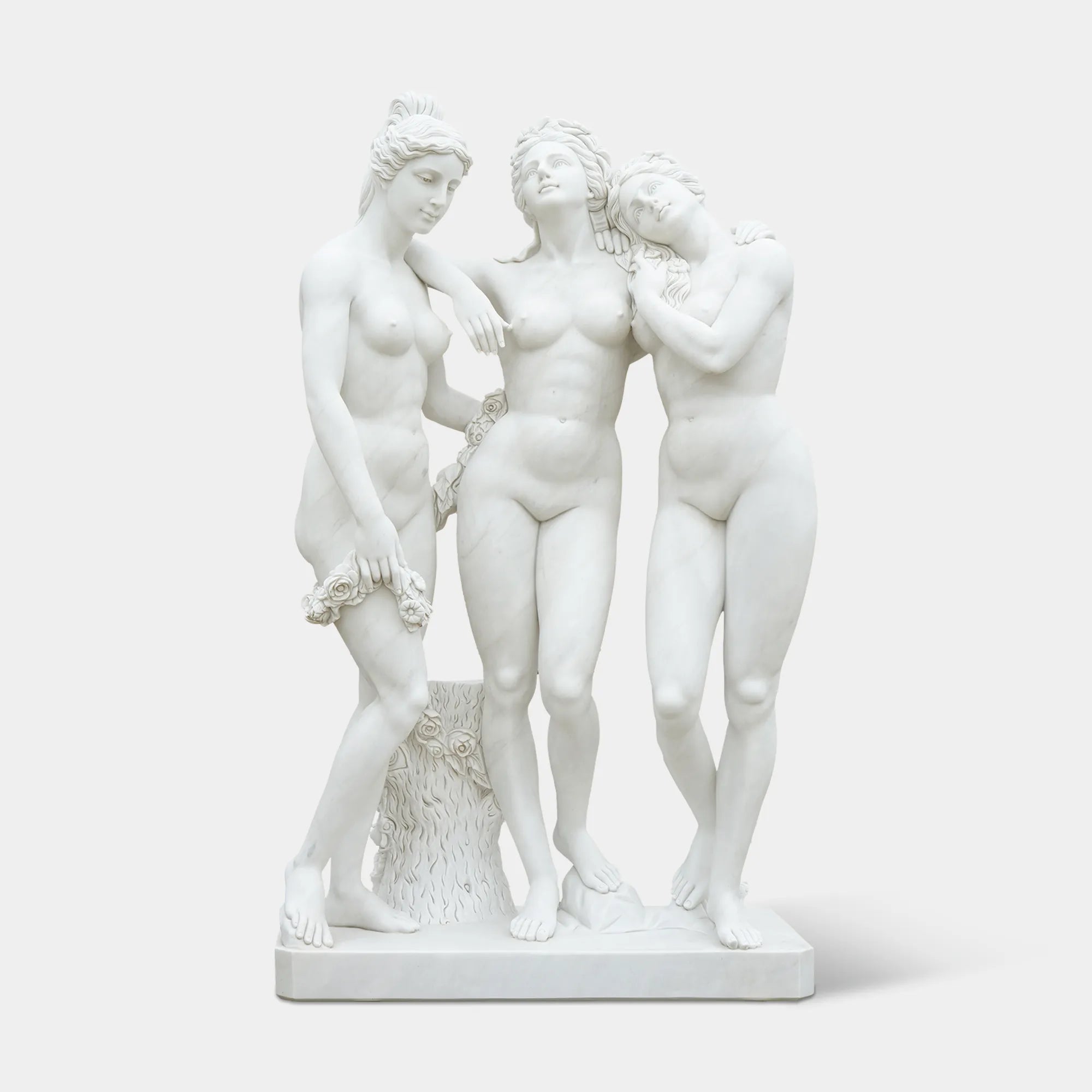 Three Graces marble statue with three intertwined female figures in white marble for garden, patio, courtyard, and terrace corner.