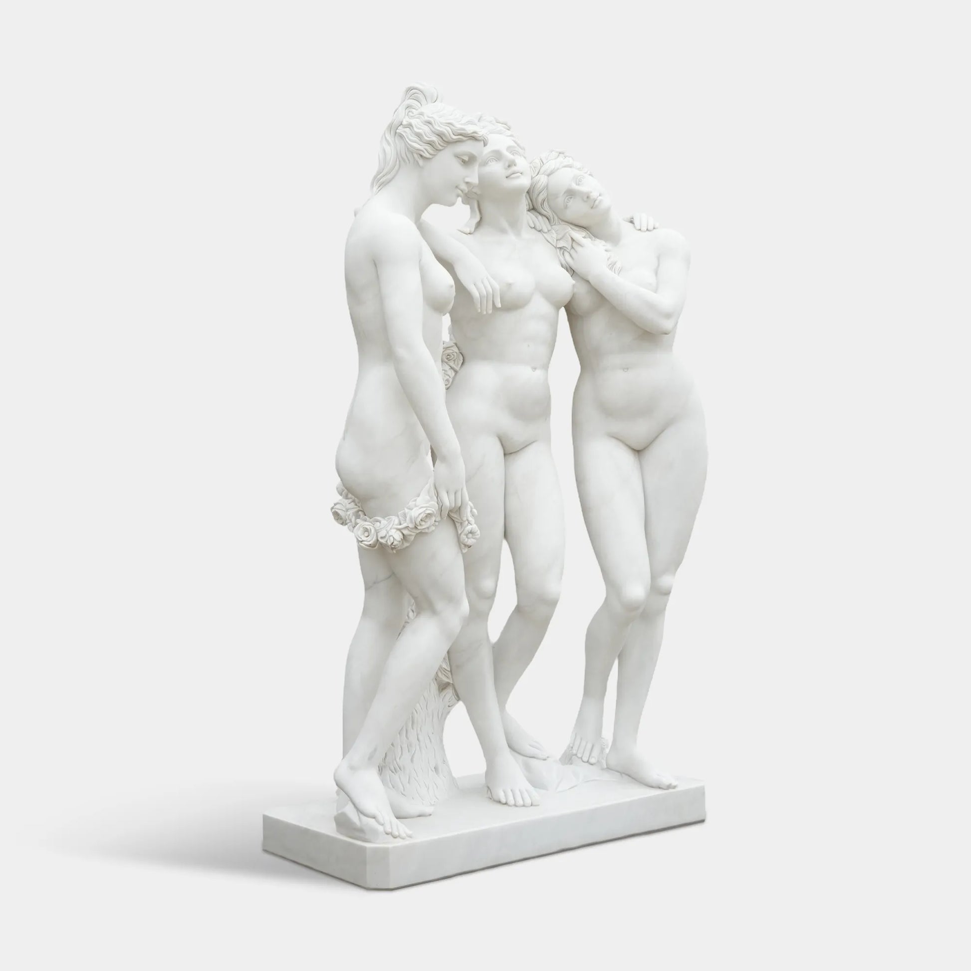 Three Graces marble statue with three intertwined female figures in white marble for garden, patio, courtyard, and terrace corner.