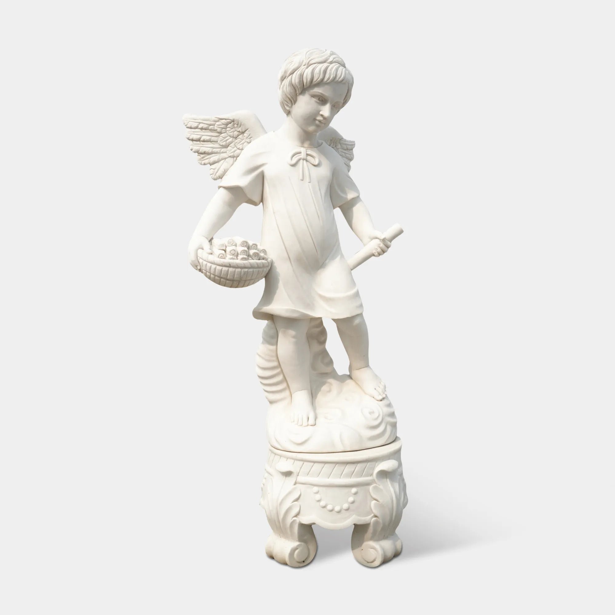 Marble angel statue holding a basket, placed along a garden path surrounded by flowers.
