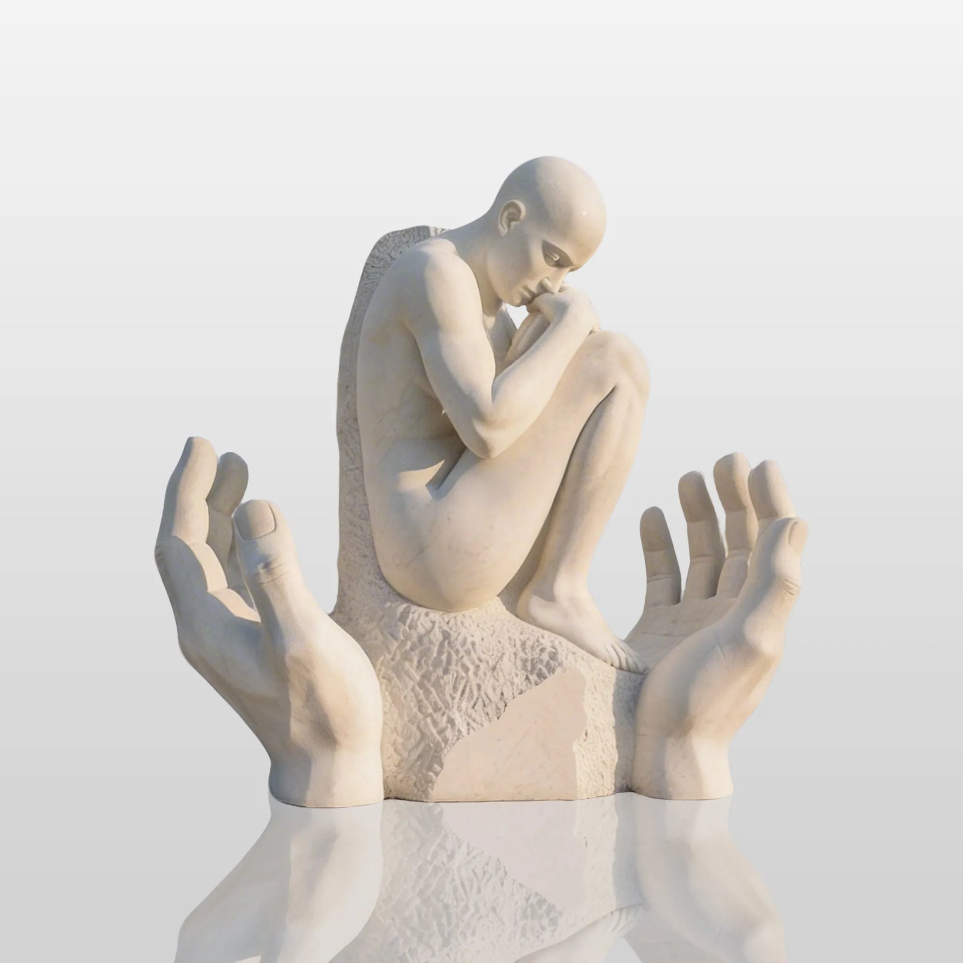 A marble human figure resting in the hands in an art gallery.