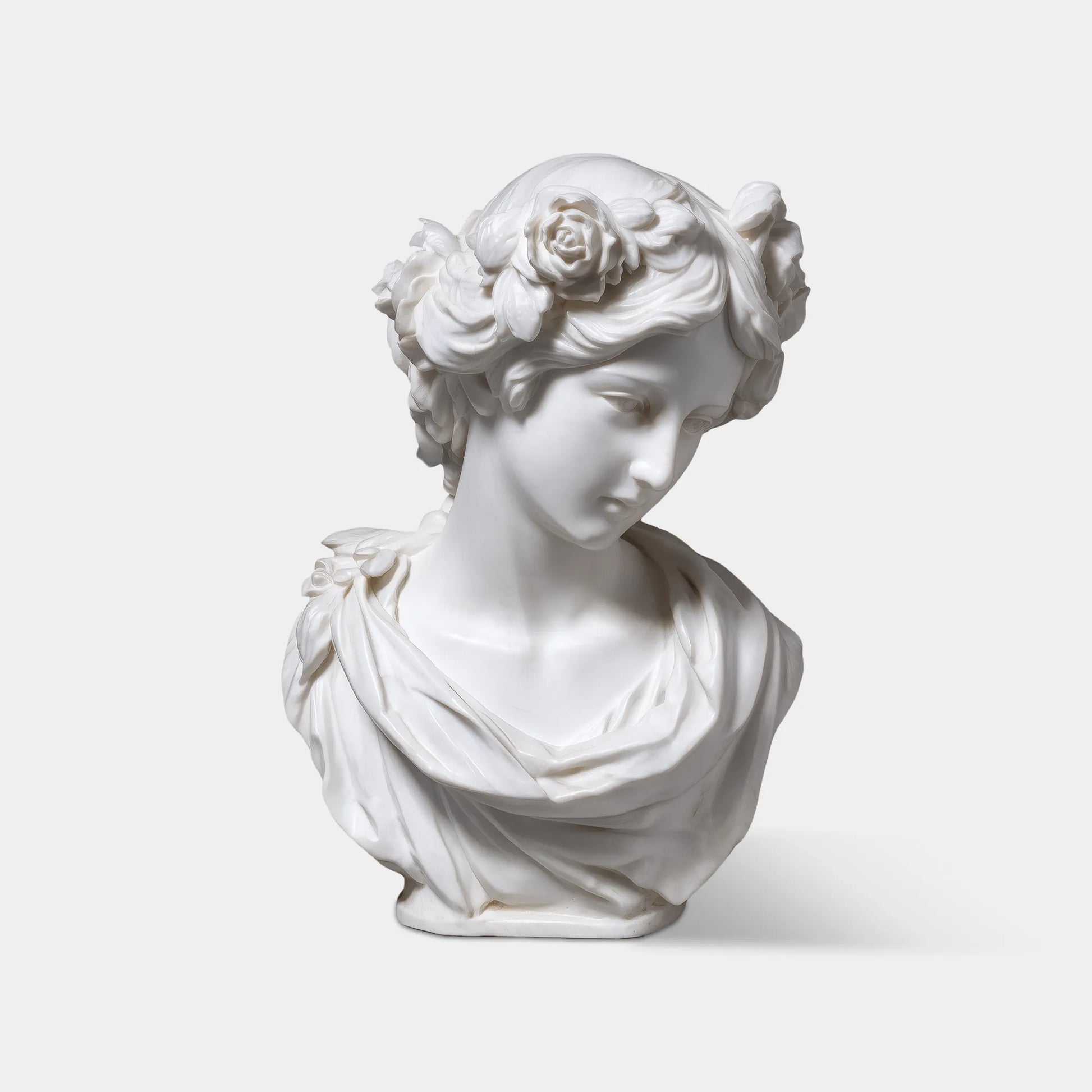 Marble female bust wearing a floral crown, detailed facial features, smooth finish, suitable on window sills.