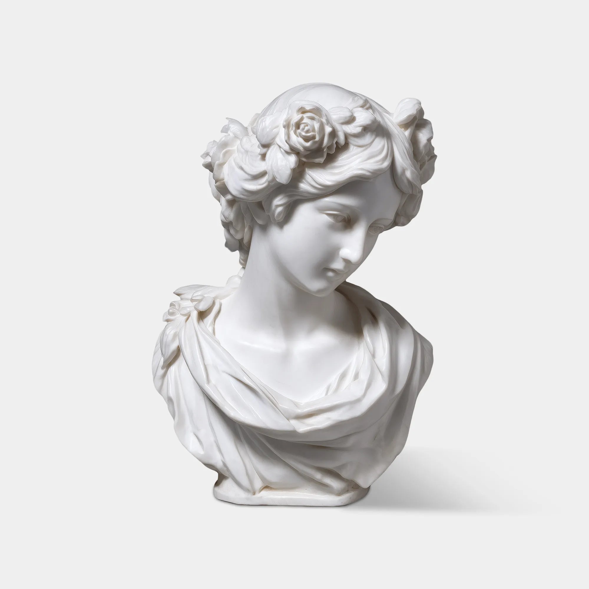 Marble female bust wearing a floral crown, detailed facial features, smooth finish, suitable on window sills.