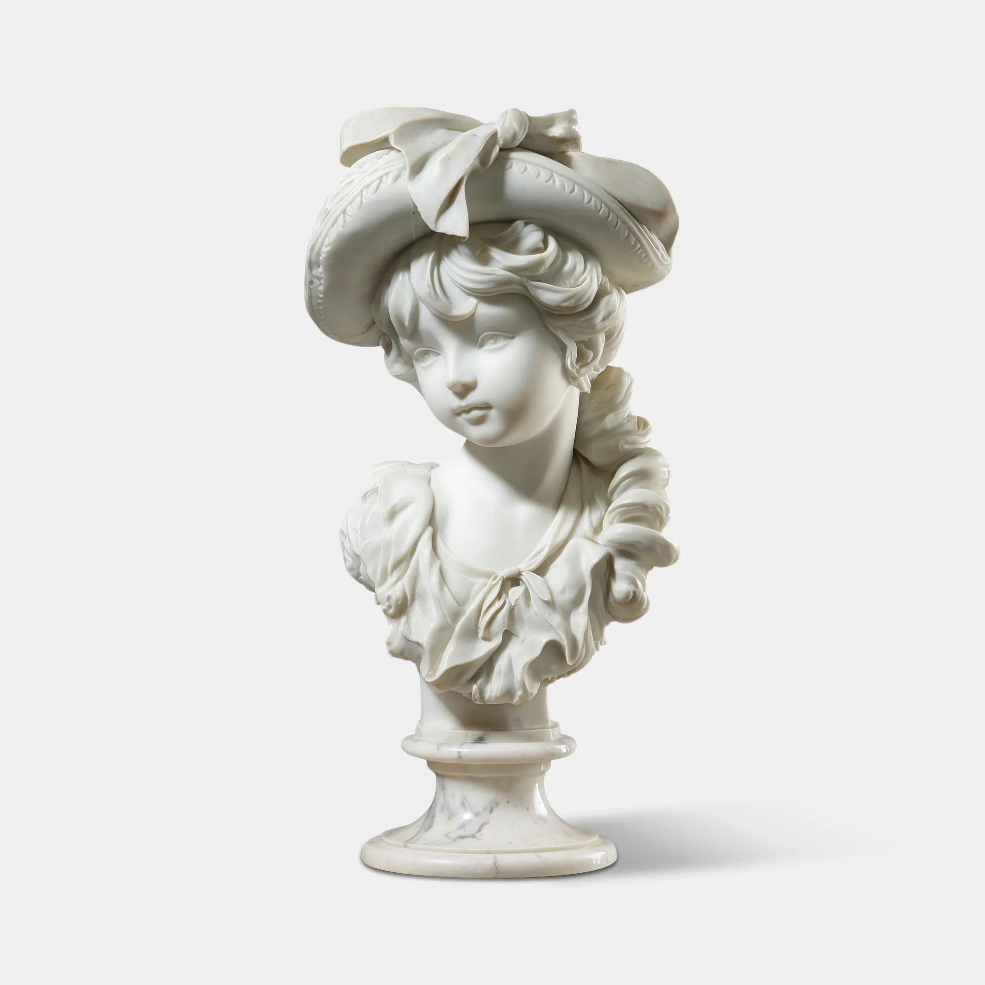 A white rococo girl marble bust sits on a console table inside a warm lit antique style room.