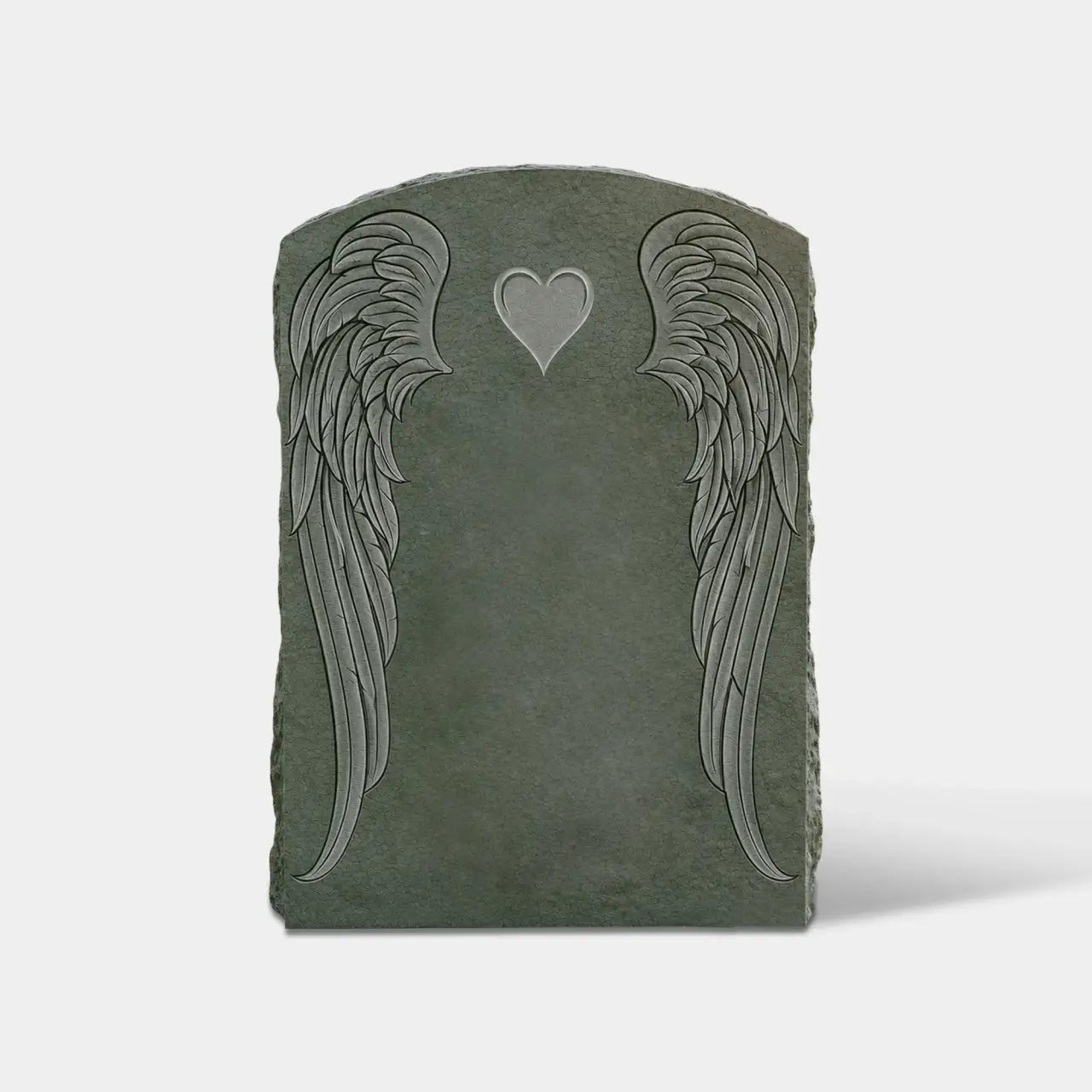 Dark marble headstone carved with two angel wings and a heart sits on green cemetery grass surrounded.