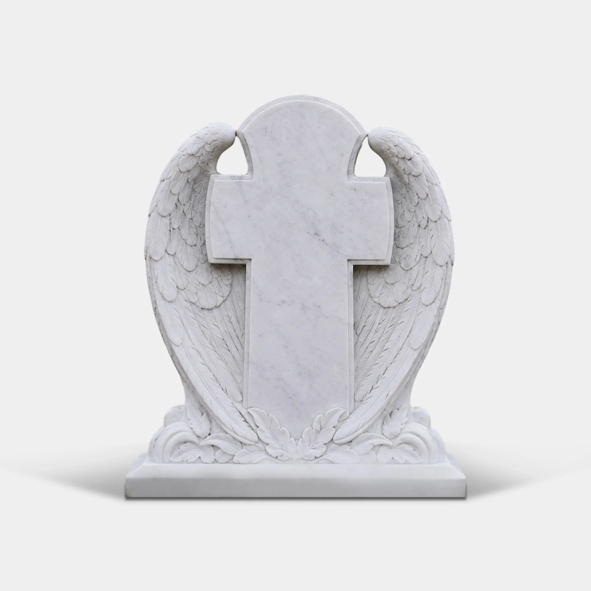 White marble headstone carved with wing wrapping a cross stands on the grass cemetery ground.
