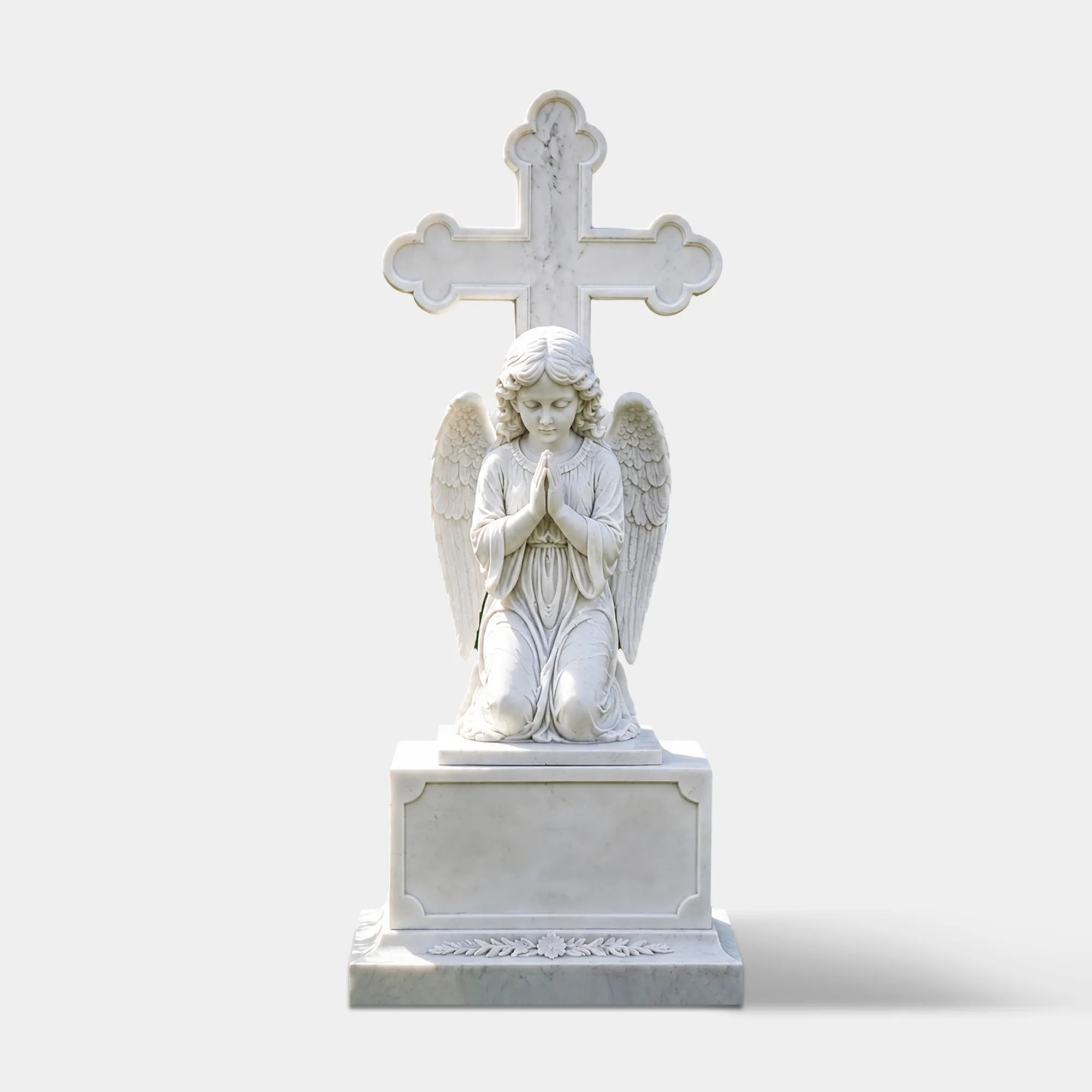 White marble angel headstone rests on green grass amid cemetery flowers.