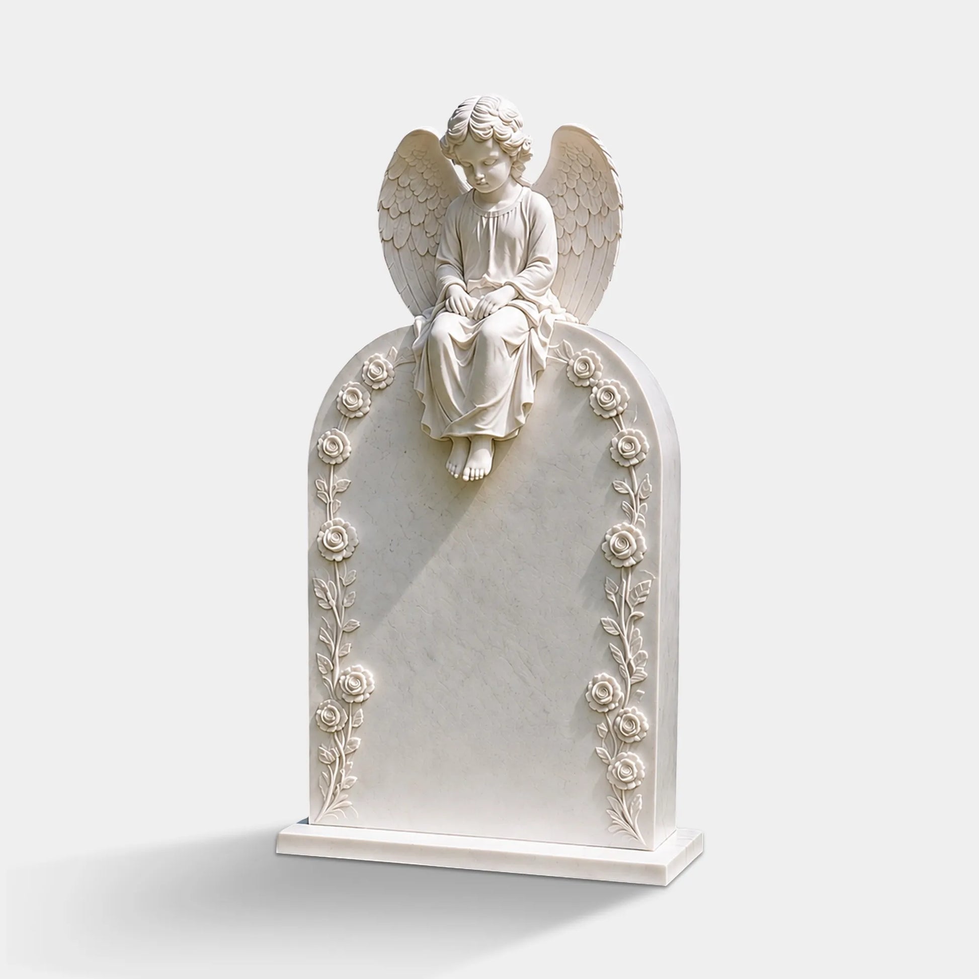 White marble cherub headstone with floral carvings stands on green lawn surrounded by rose bushes.