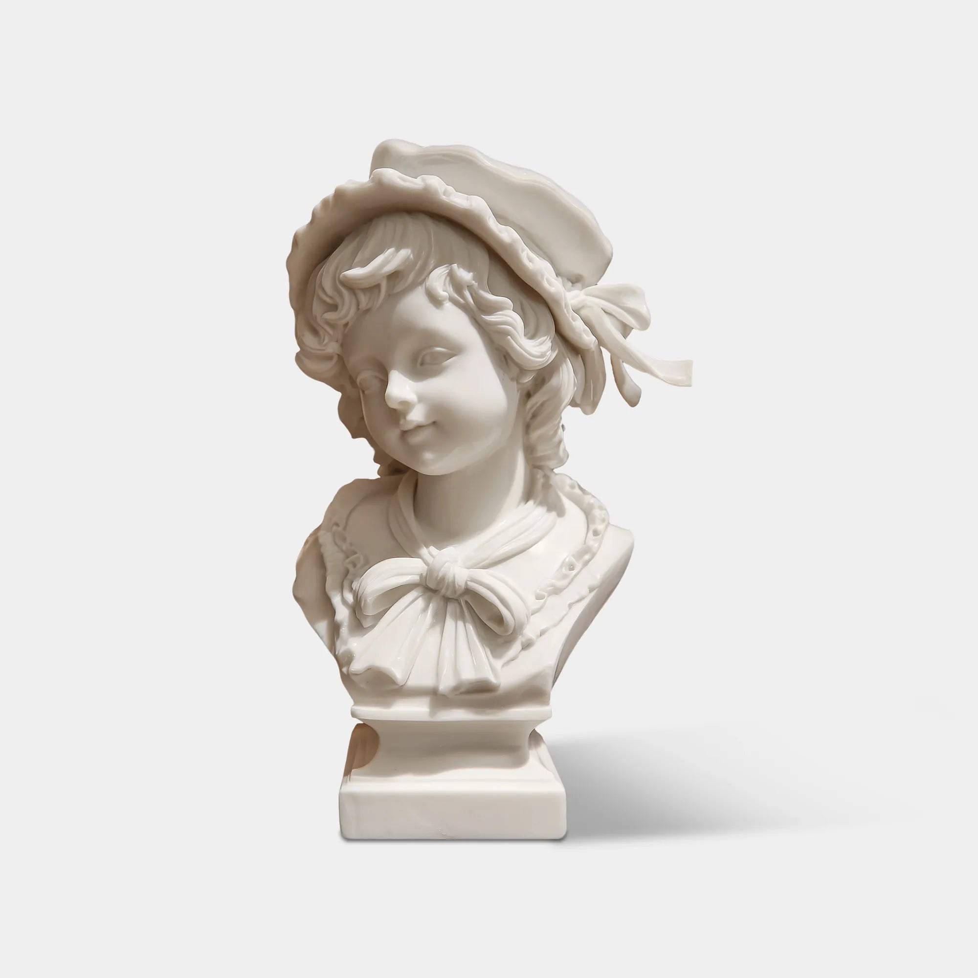 Marble girl bust sculpture rests on the marble table inside a classic living room.