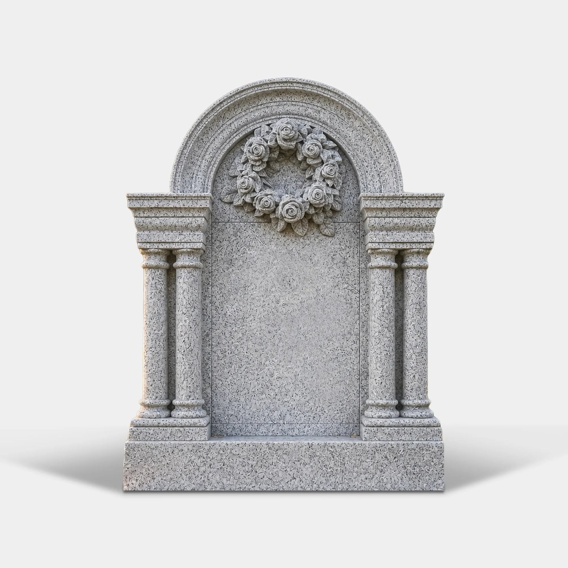 A light gray granite tombstone with columns and rose wreath carving sits on grass inside a cemetery.