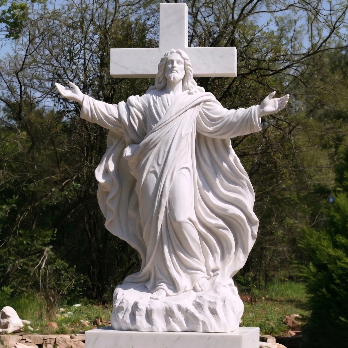 White marble Jesus statue with cross stands on the stone base among trees.