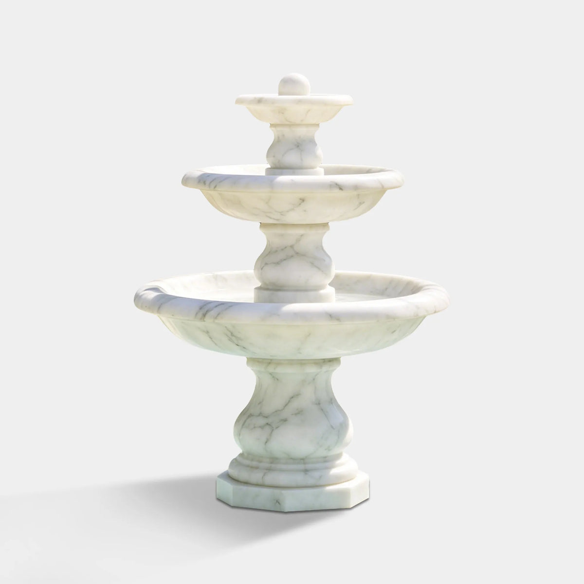 A three tier marble fountain sits inside an octagonal pool in a residential front yard.