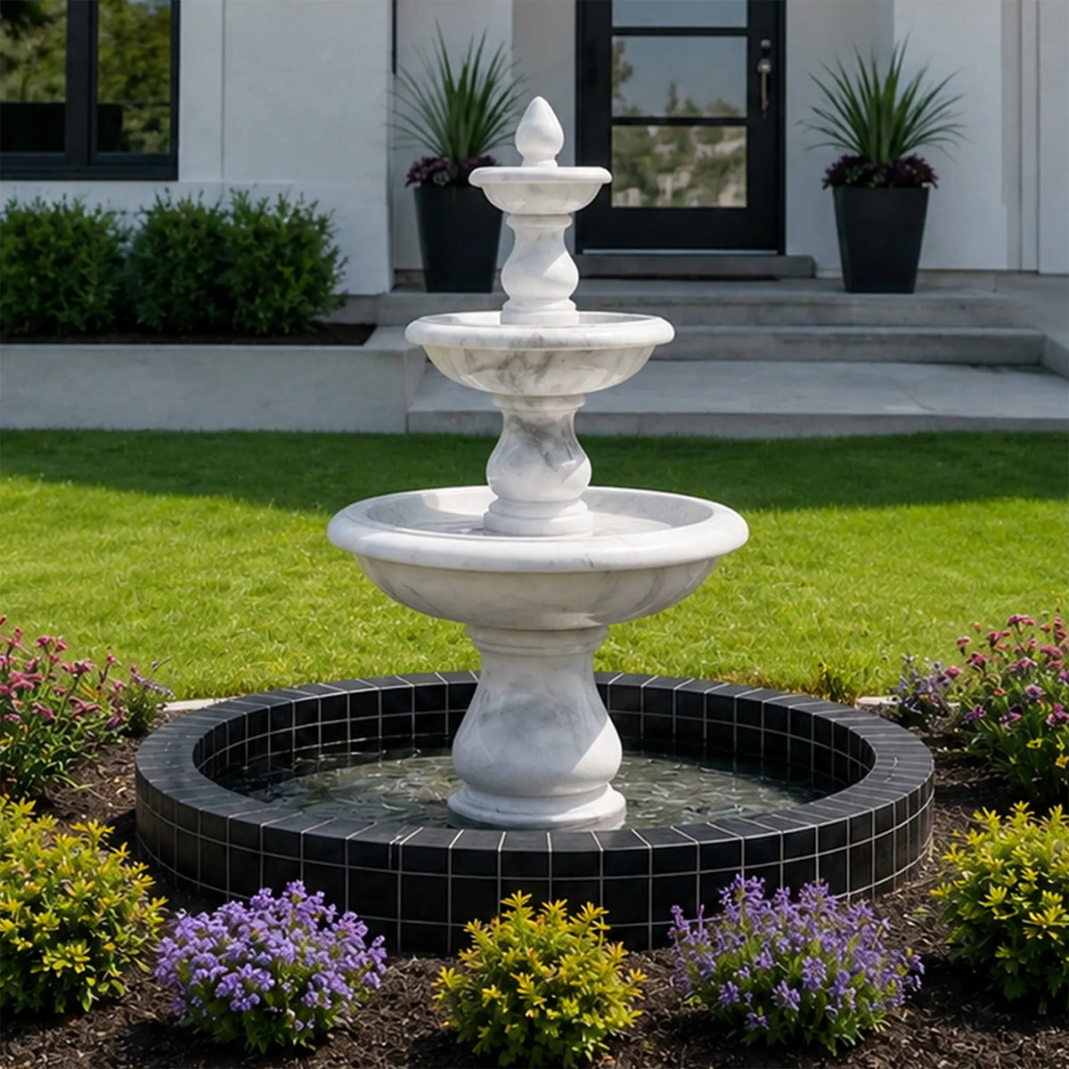 White marble three-tier fountain with rounded basins in a landscaped front garden