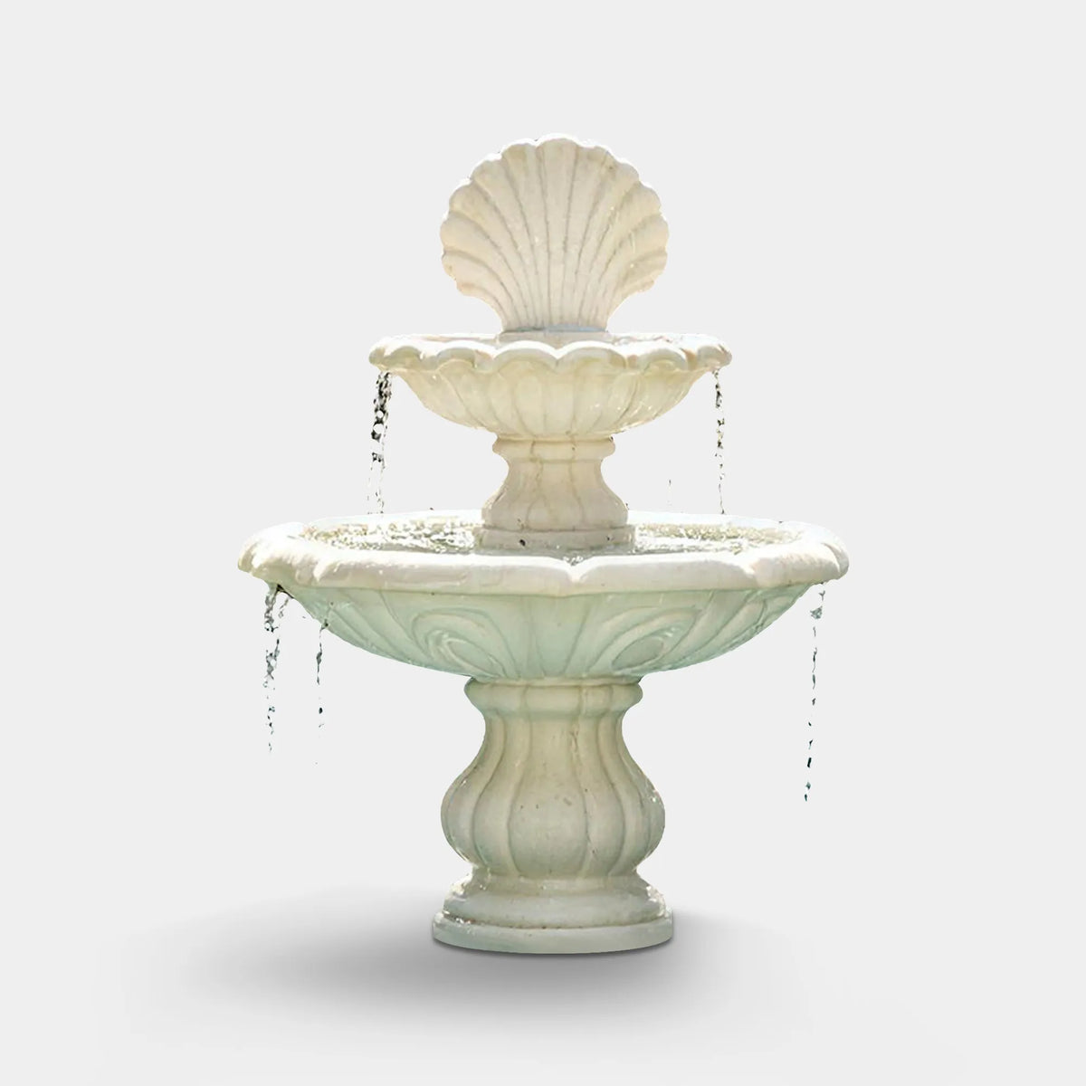 A white marble fountain with seashell top sits inside a residential swimming pool.