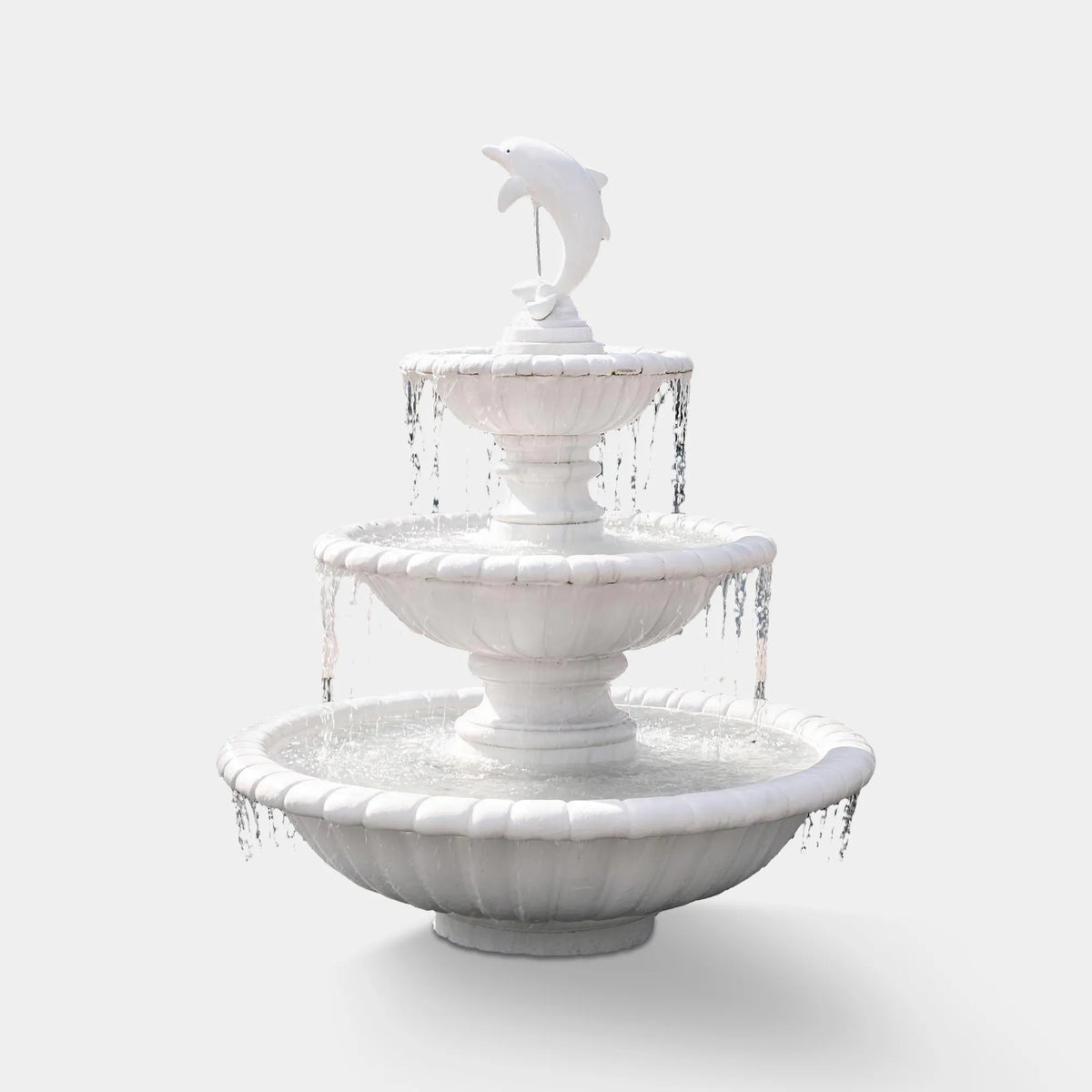 A three tier marble fountain with dolphin statue sits in a circular basin outside a residential home.