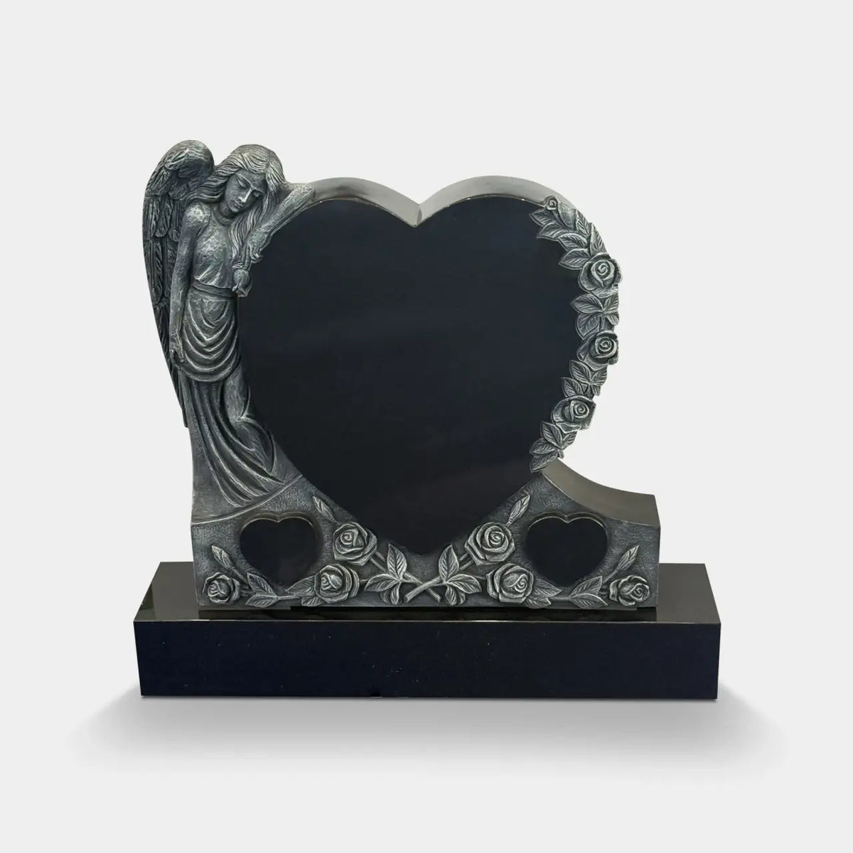 Marble Angel Memorial Headstone with a Heart-Shaped Black Inscription Panel, Sculpted Angel, Detailed Rose and Leaf Decorations, and Two Smaller Heart Designs at the Bottom