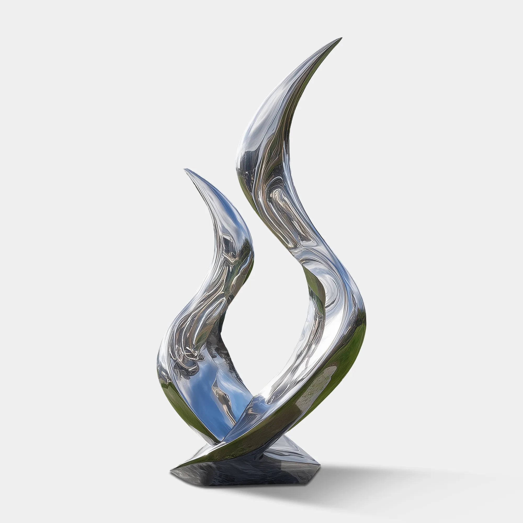Polished stainless steel flowing abstract sculpture on stone base in green lawn in front of modern villa
