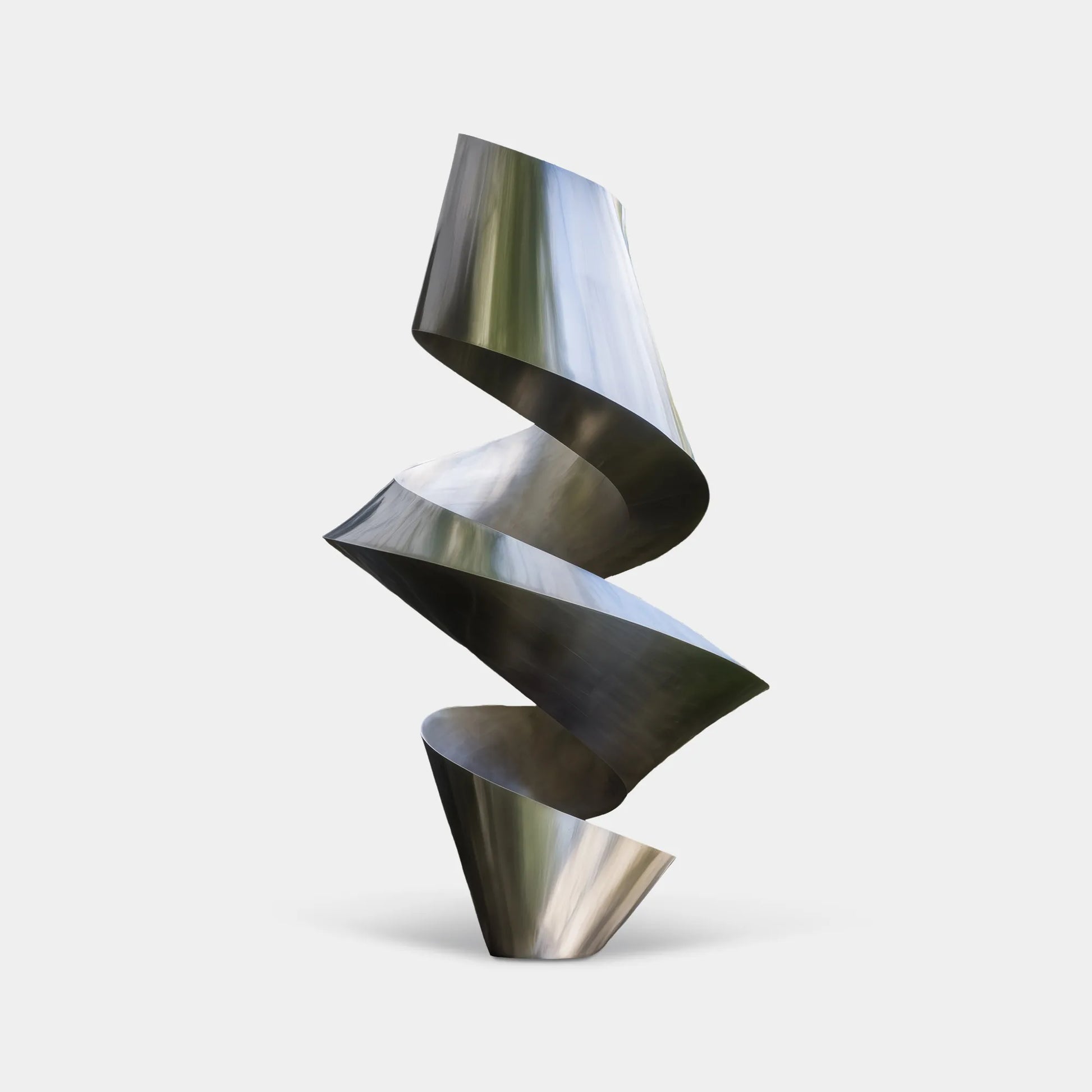 Brushed stainless steel spiral sculpture with twisting layered form on square base in courtyard lawn beside modern building