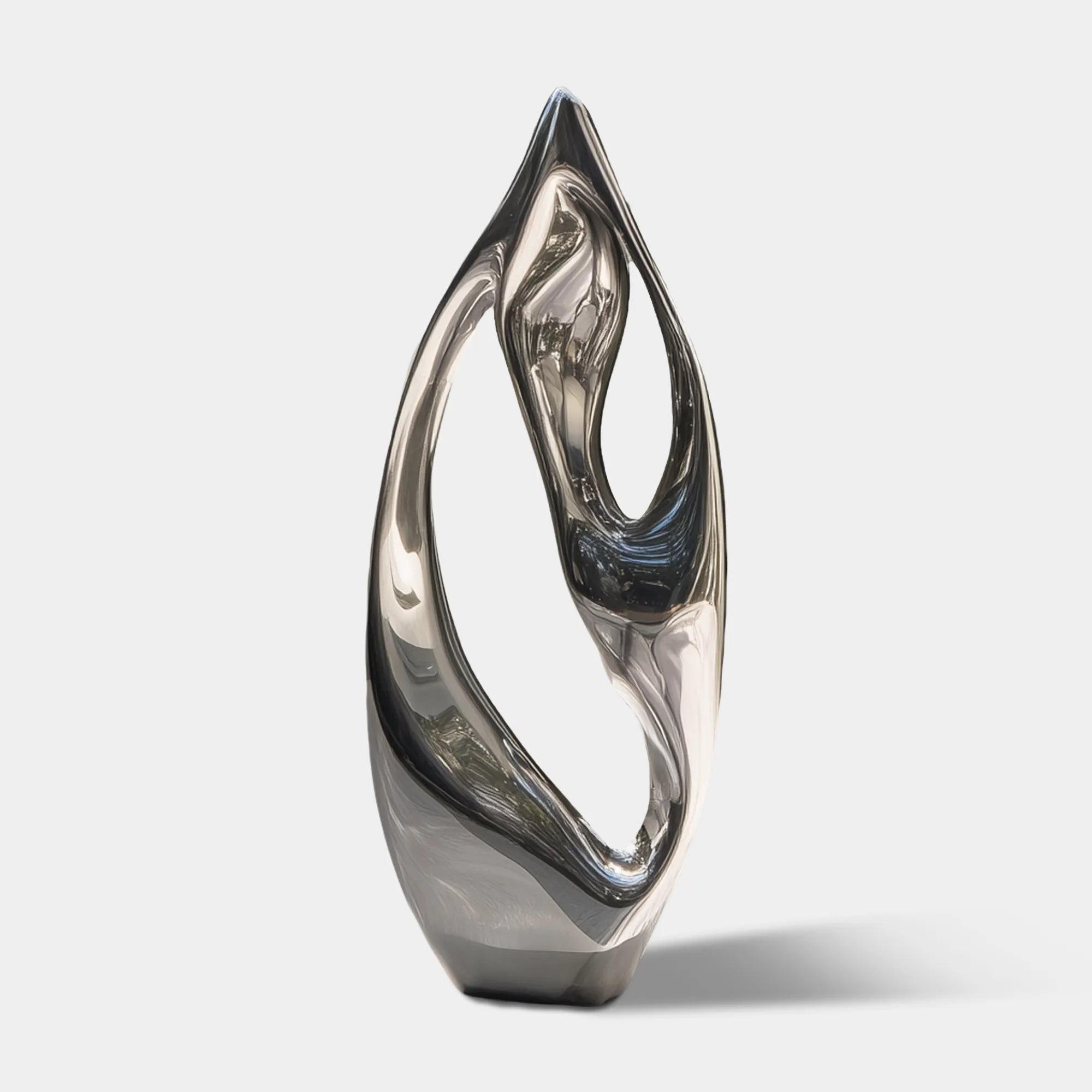 Polished stainless steel abstract sculpture with open organic form on rectangular pedestal in front of marble wall and glass façade