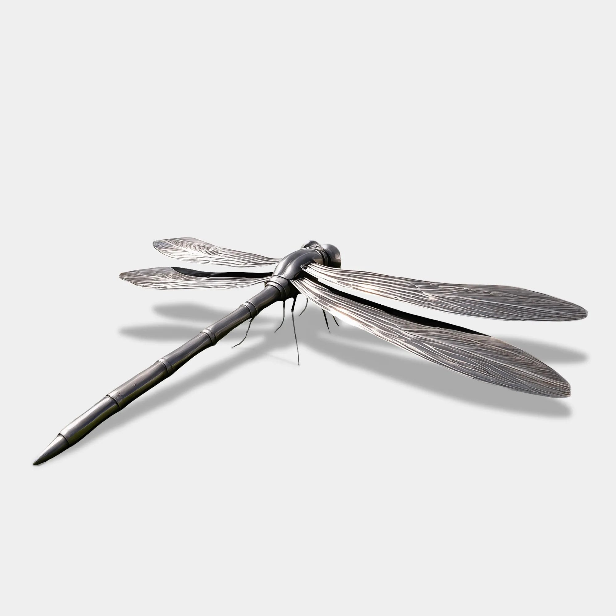 Stainless steel dragonfly sculpture on grass in front of a modern villa.
