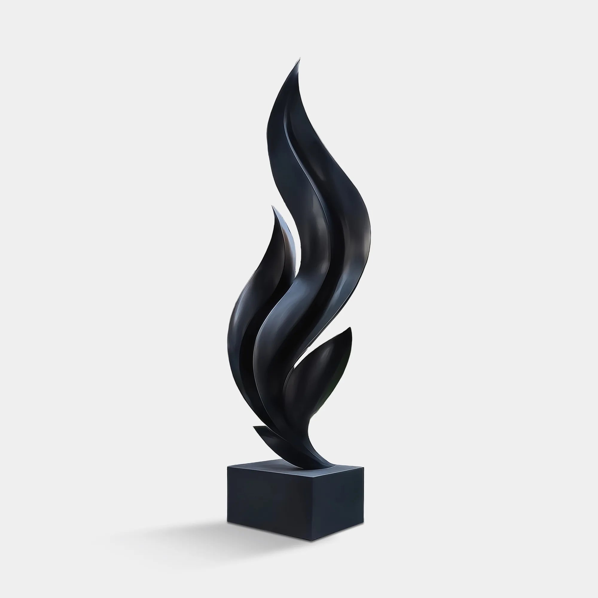 Stainless steel abstract sculpture with flowing vertical curves in courtyard in front of modern residential building.