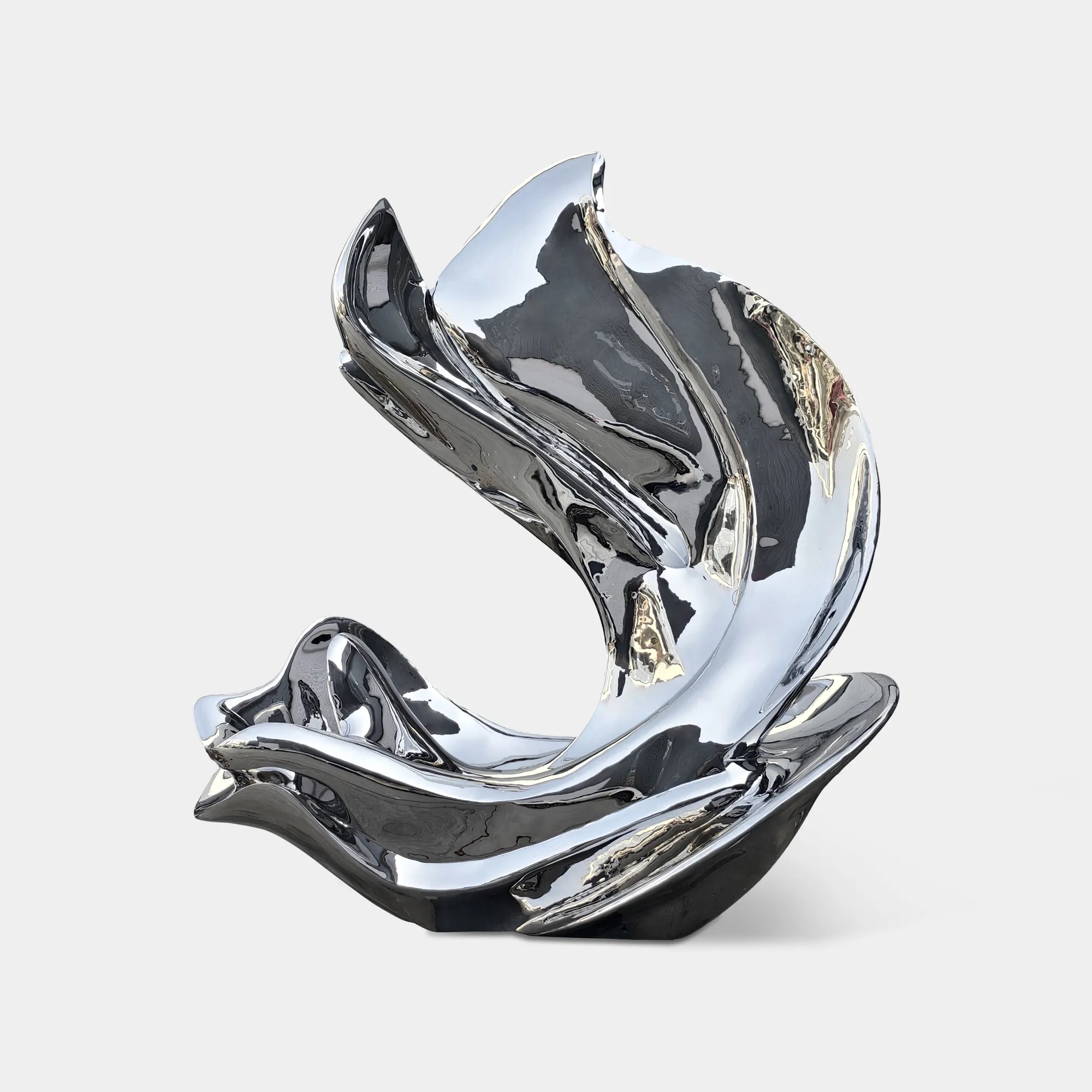 Mirror polished stainless steel abstract sculpture with fluid curved form beside pool with glass building. 