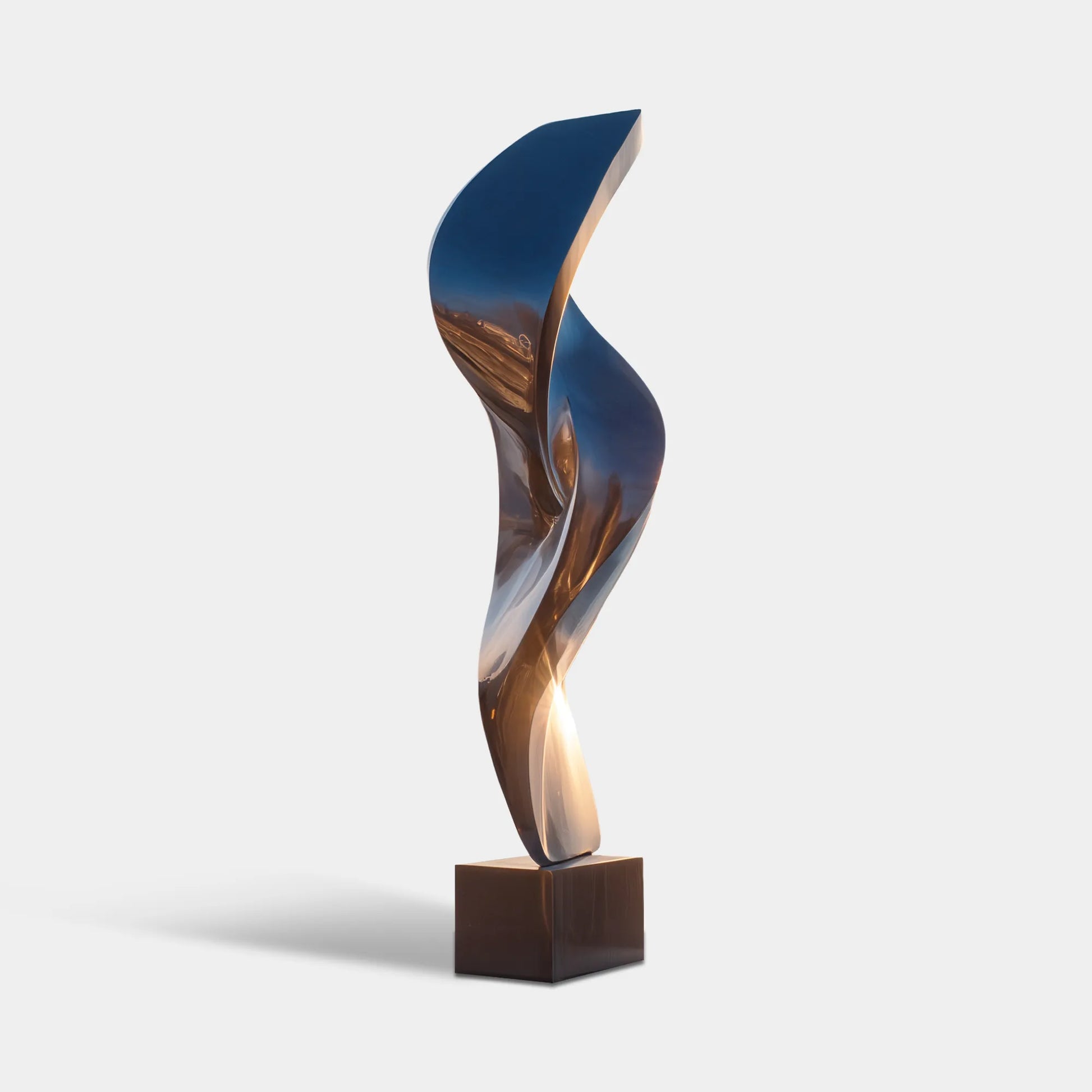 Polished stainless steel flowing sculpture beside an infinity pool with ocean and mountain views.