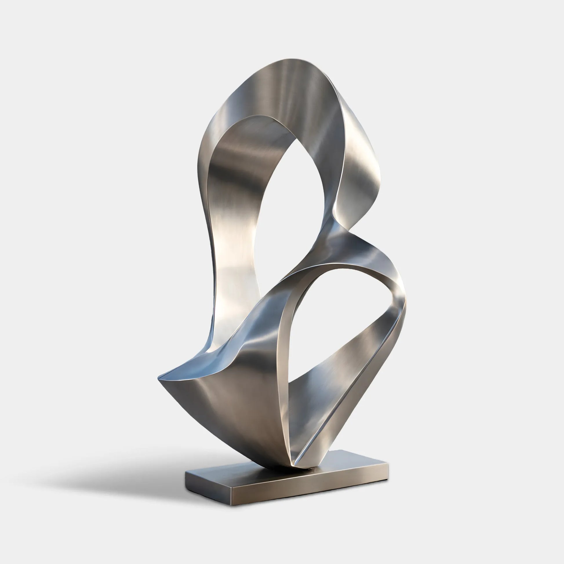 Brushed stainless steel abstract sculpture with flowing hollow forms beside an infinity pool and coastal modern villa terrace.