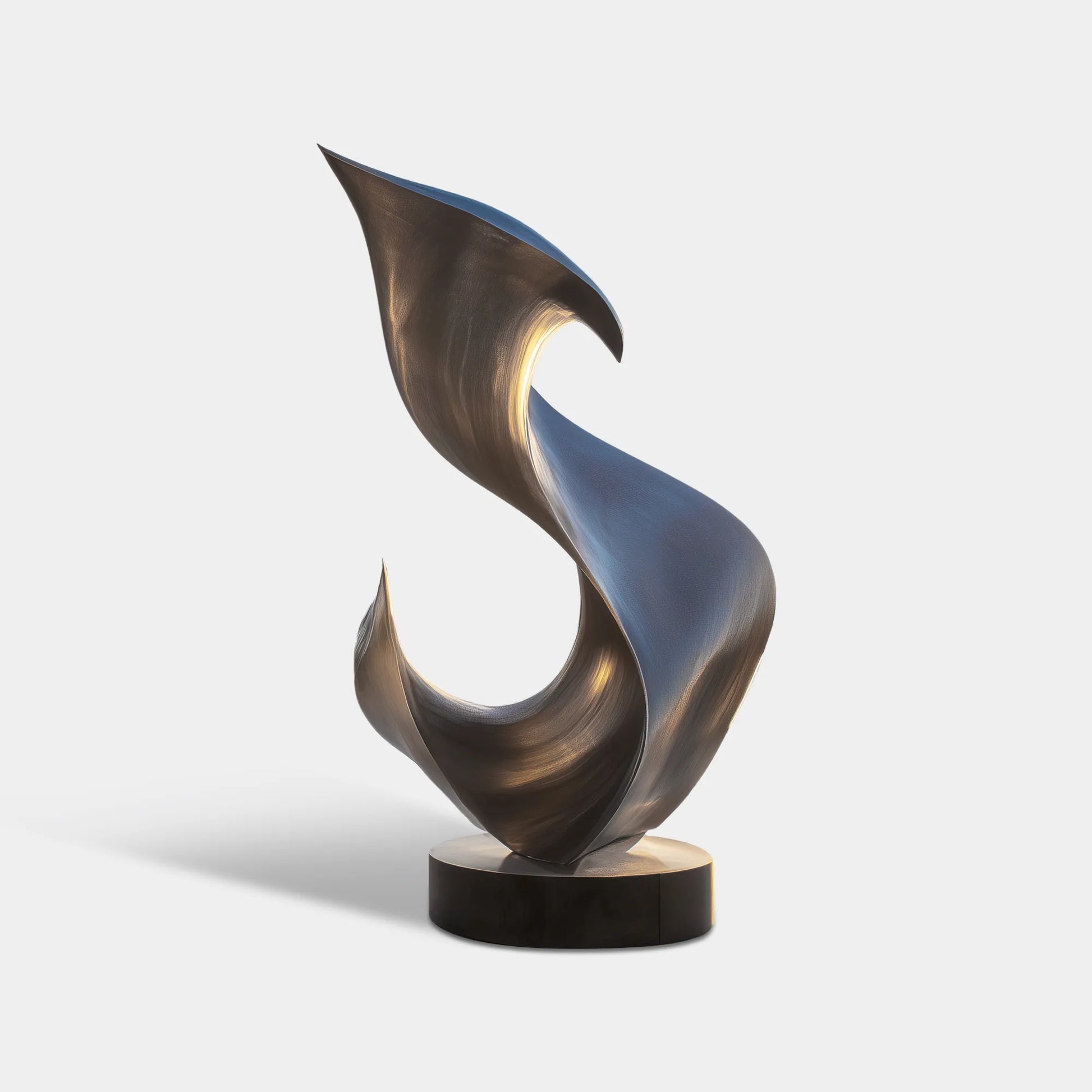Abstract brushed stainless steel sculpture with flowing curved form on a round base beside a luxury pool terrace overlooking the ocean.