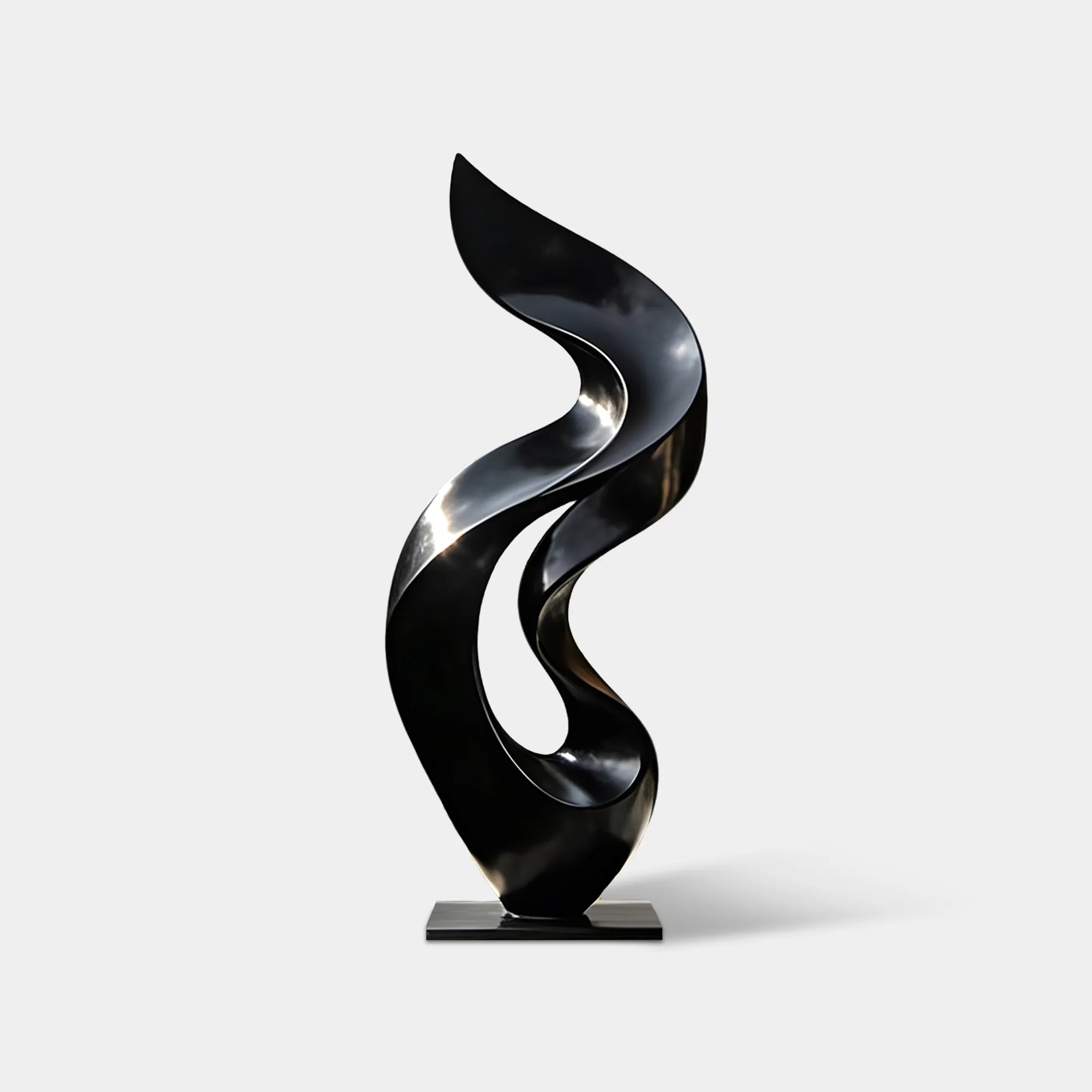 Black stainless steel abstract sculpture with flowing open form on a pedestal in a modern residential garden courtyard.