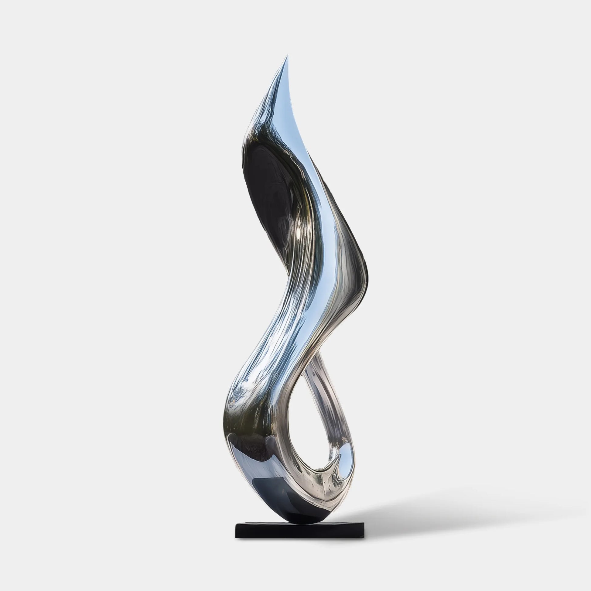 Polished stainless steel flowing form sculpture on a black pedestal in front of a modern glass residence.
