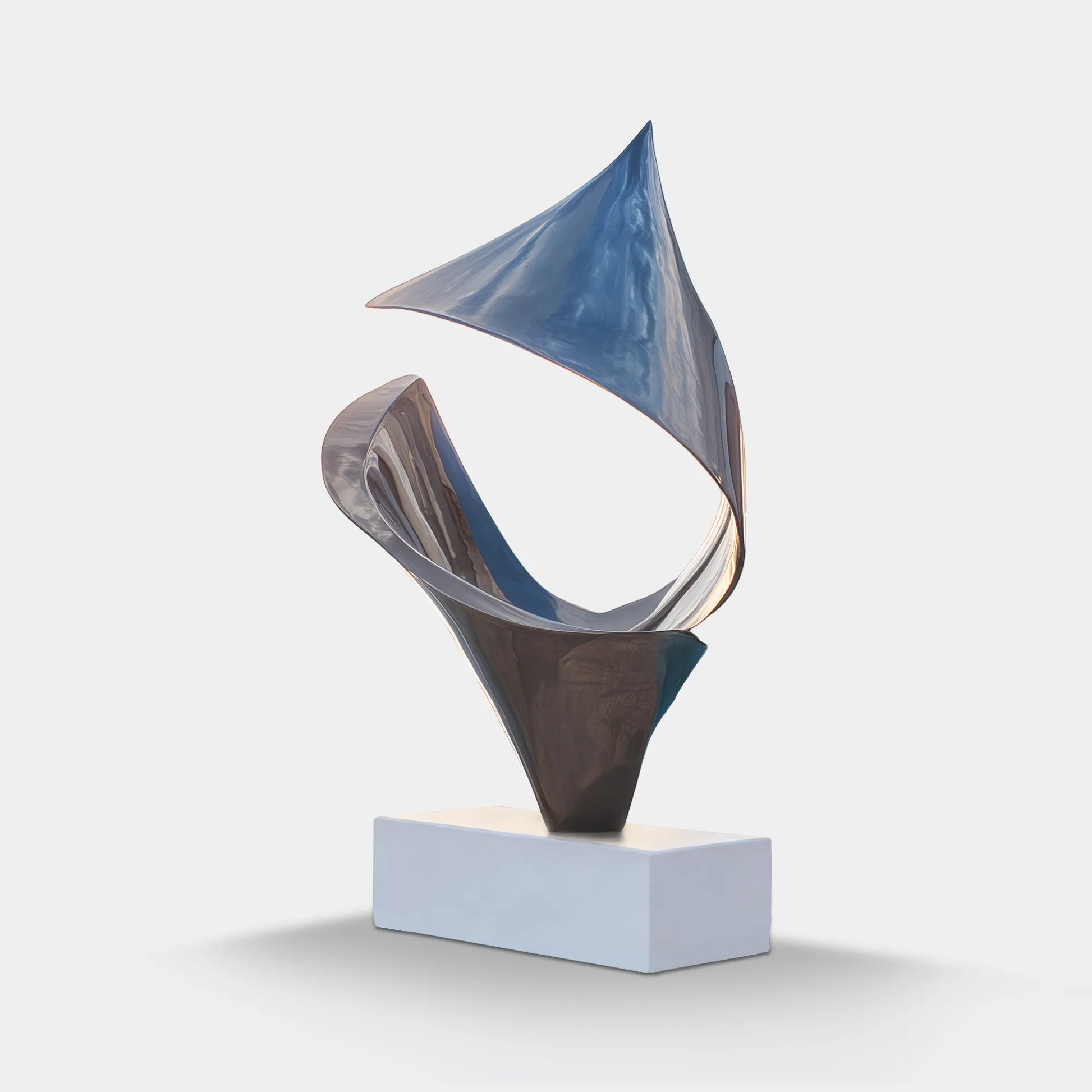 Mirror-polished stainless steel abstract sculpture with sweeping folded forms on a white rectangular pedestal beside a luxury swimming pool at sunset.