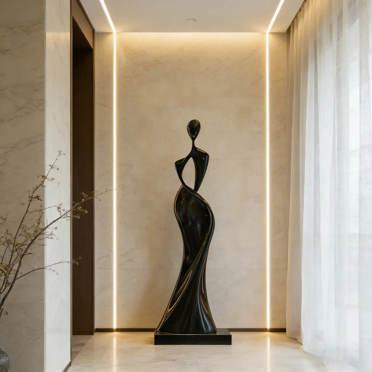 Black stainless steel sculpture in abstract twisting female design displays inside a lit residential entry hall.