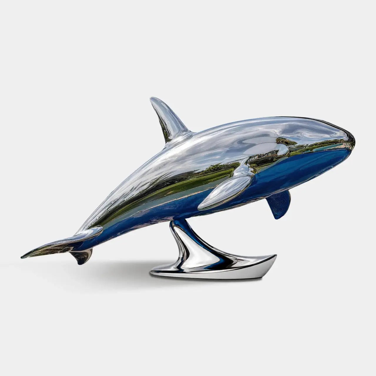A stainless steel whale statue sits beside a swimming pool at a residence.