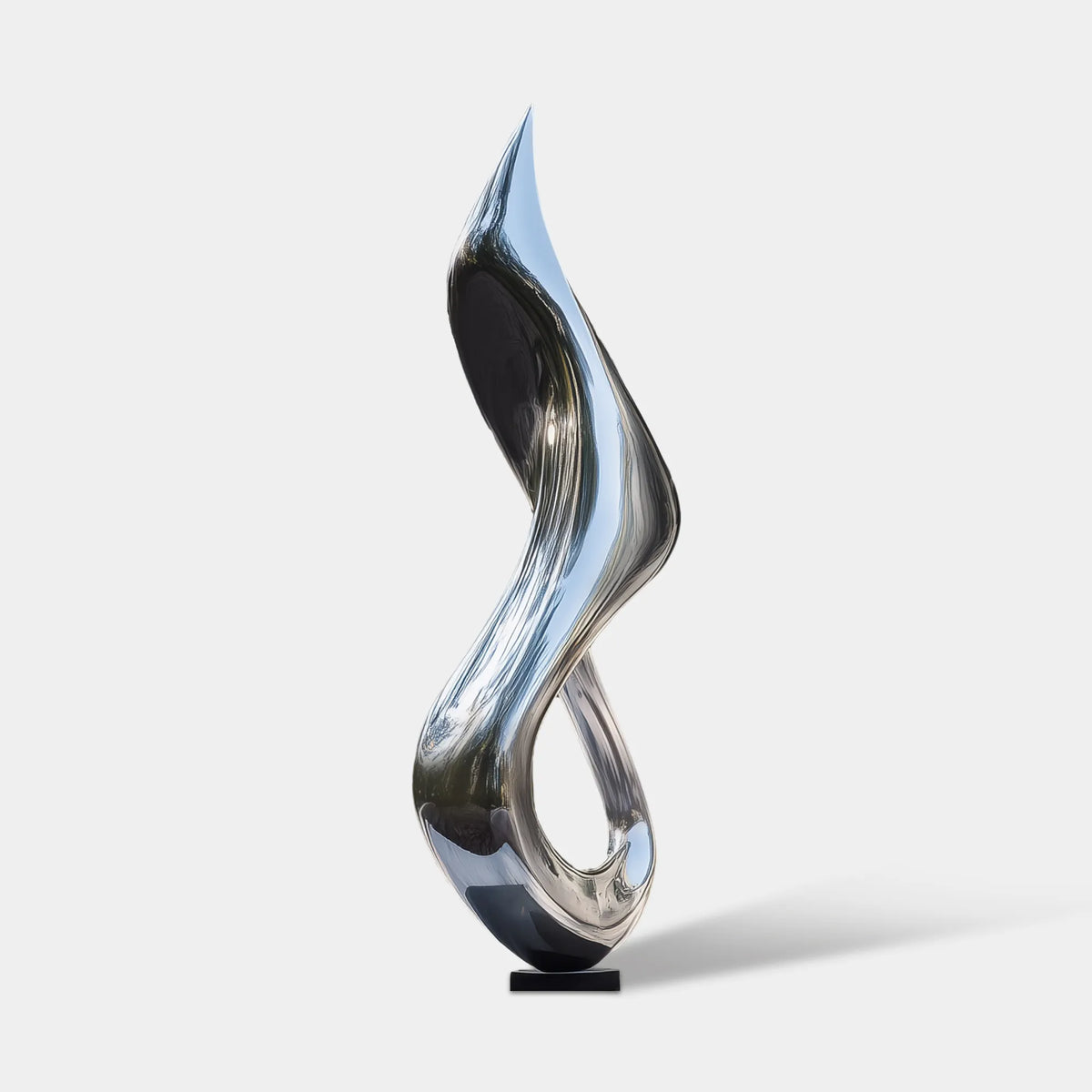 Mirror polished stainless steel abstract sculpture with a tall twisting organic form in the courtyard.