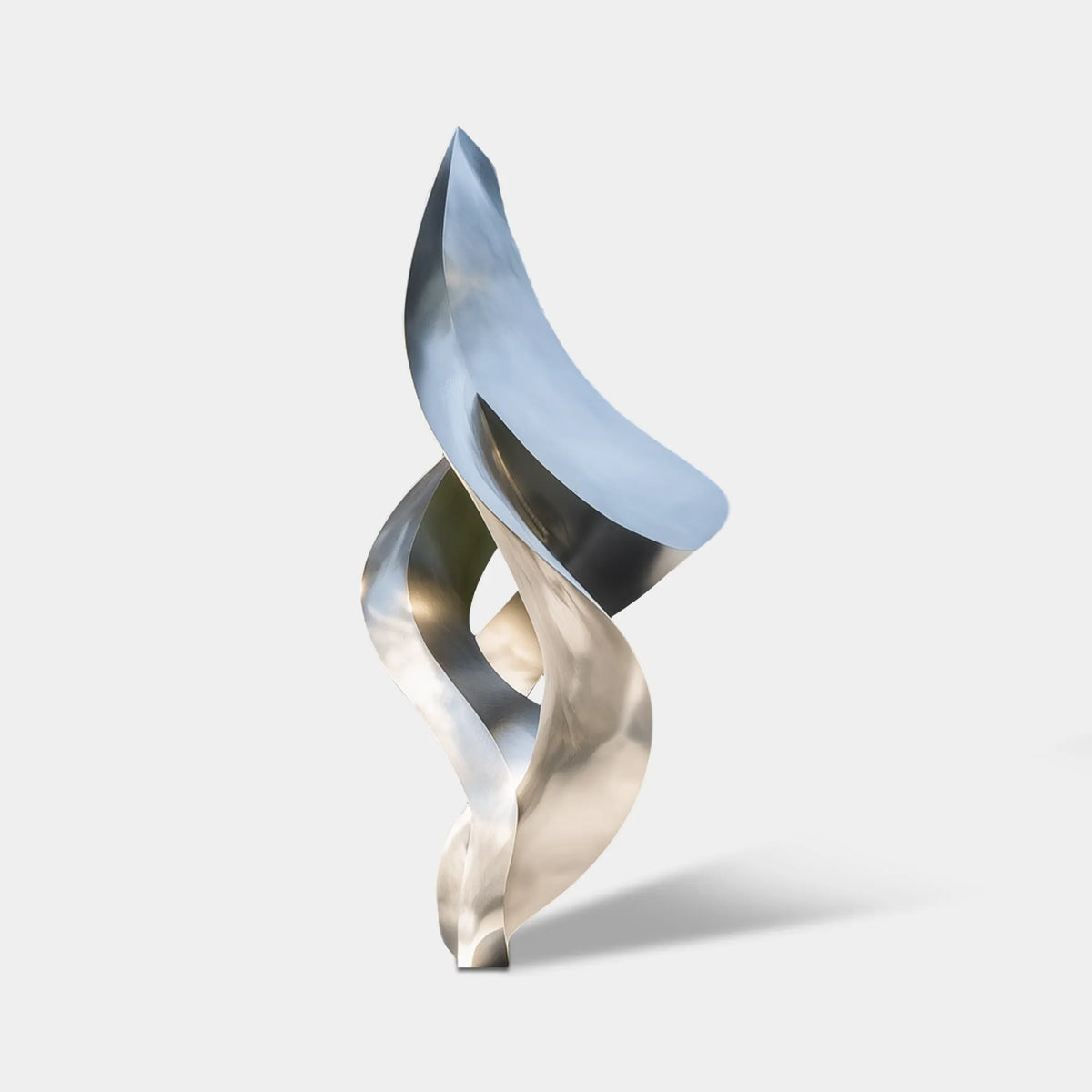 Abstract brushed stainless steel sculpture with twisting open forms in a landscaped modern residence
