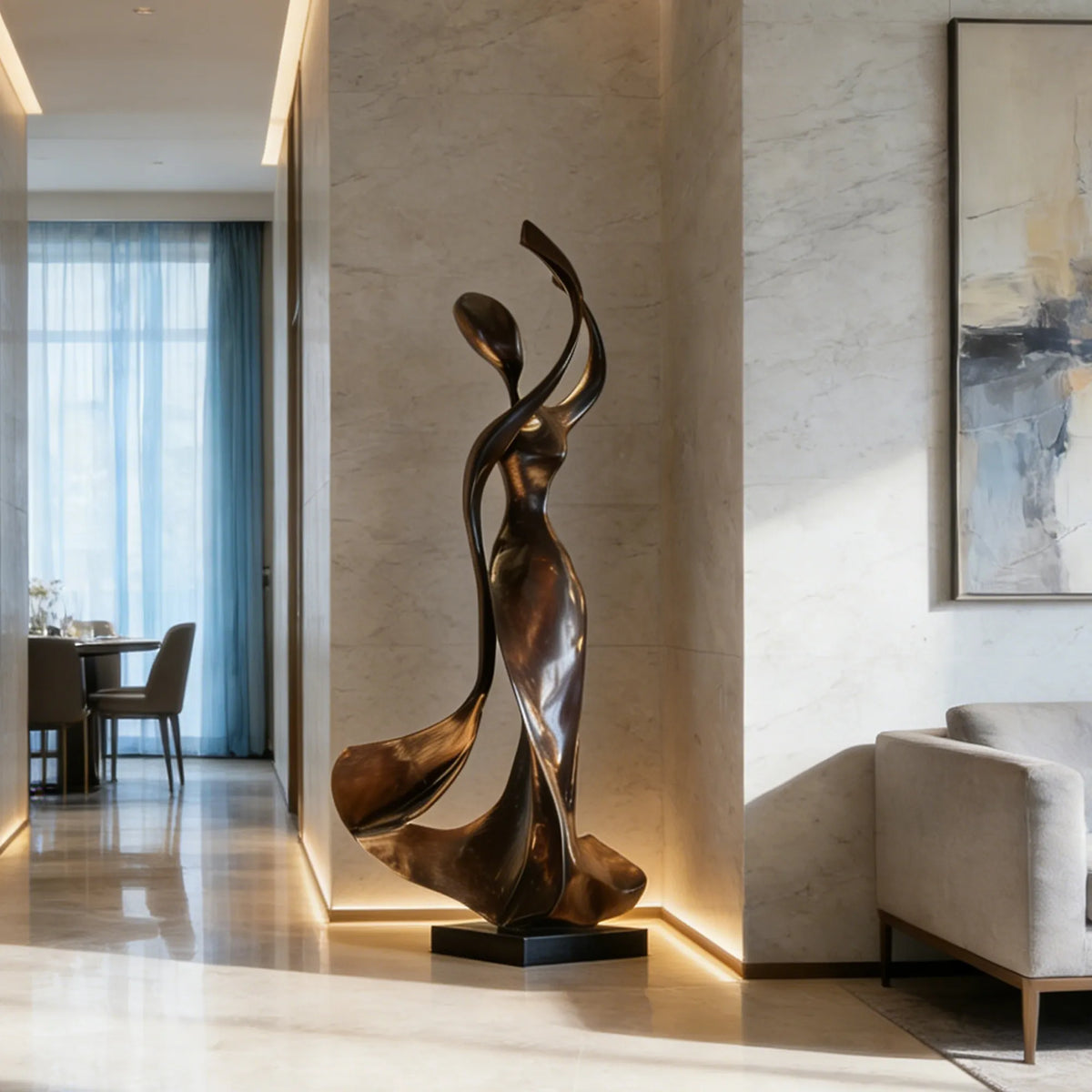 Abstract black stainless steel female sculpture with raised flowing arms and a square black base in a modern home foyer.