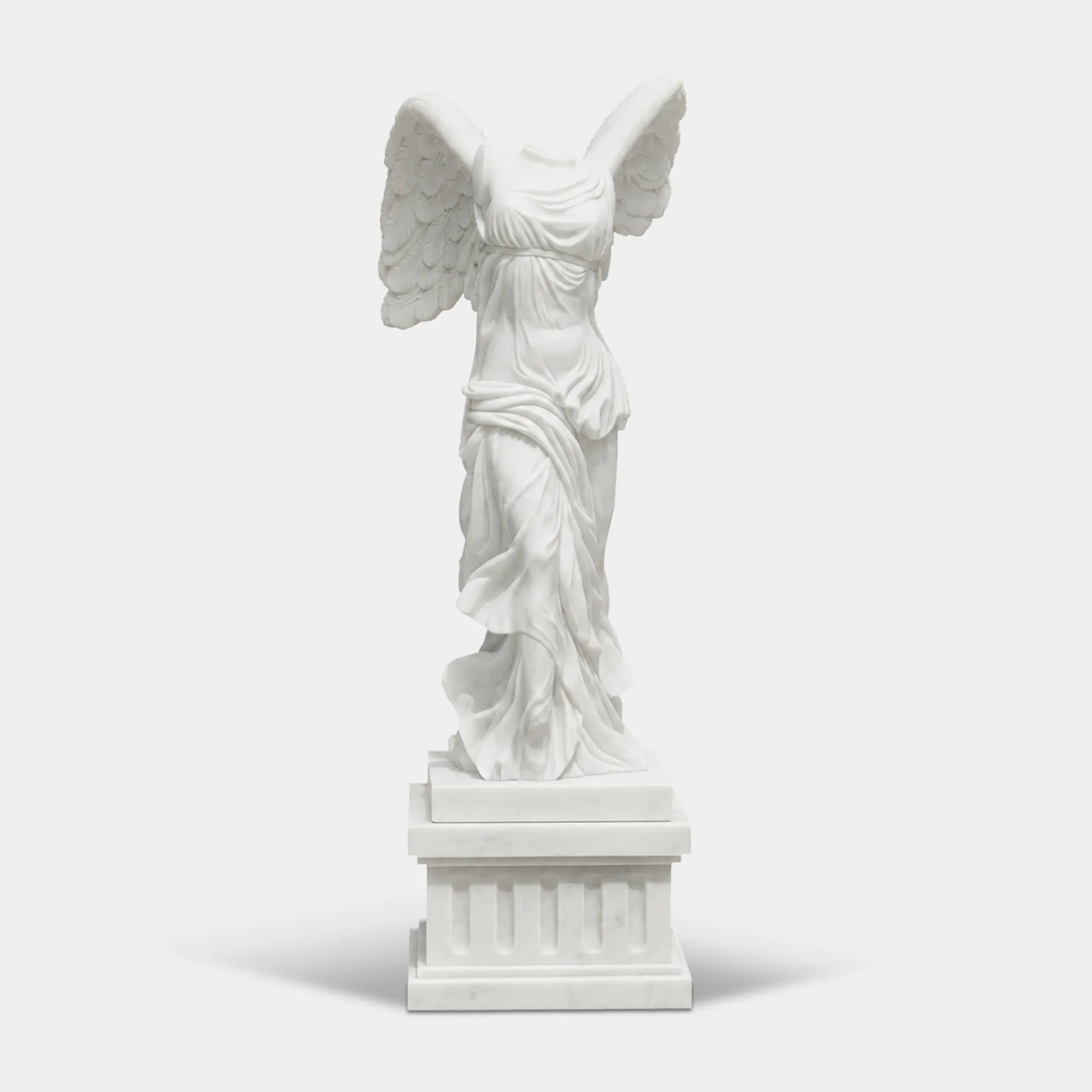 Classical marble sculpture of the Winged Victory of Samothrace with flowing drapery and soaring wings for luxury villas, courtyards, and art galleries.